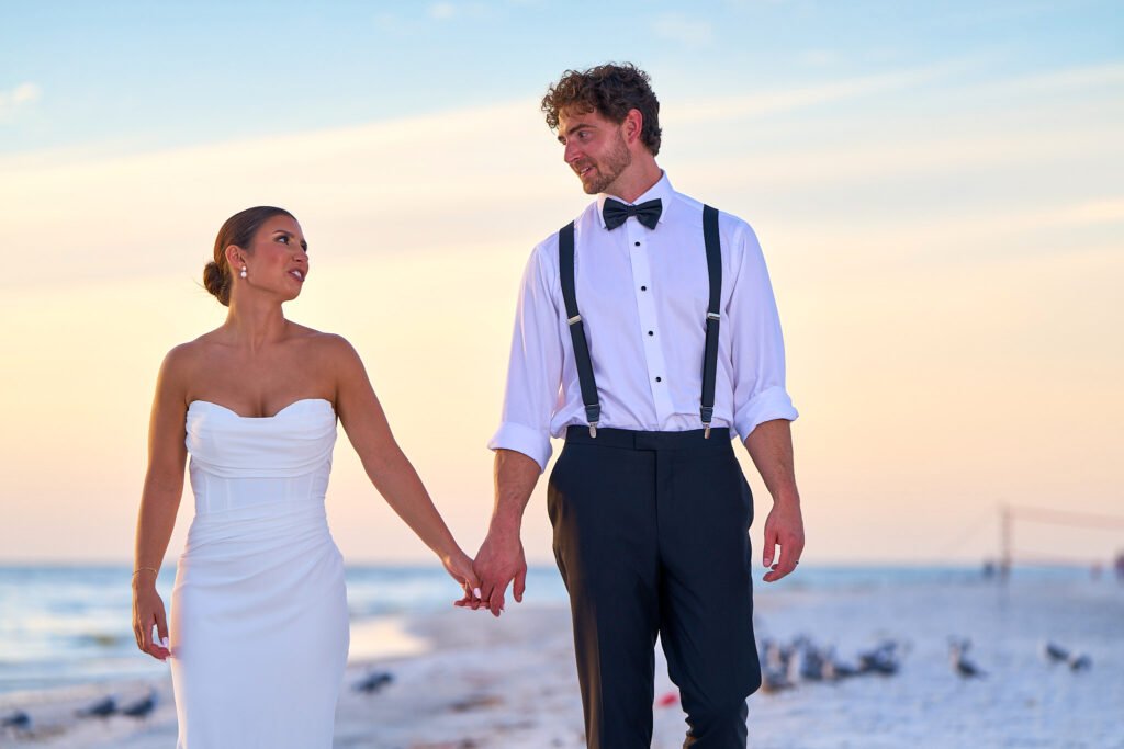Bride and groom gazing at each other at beach wedding sunset portrait session