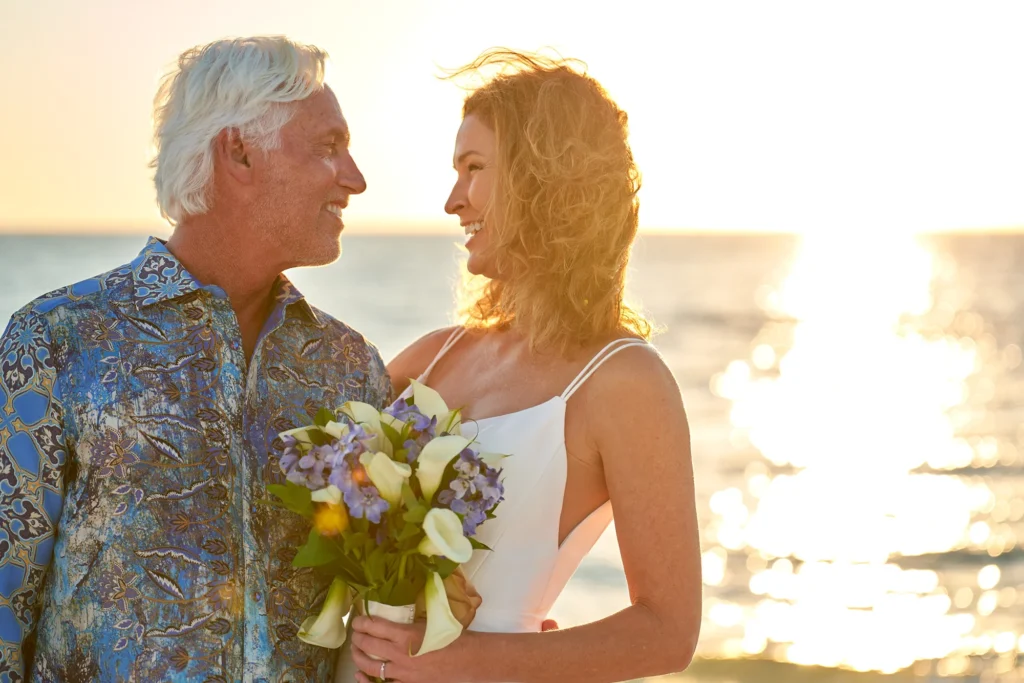 Bride and groom romantic and happy wedding day portrait at Sarasota Beach at sunset