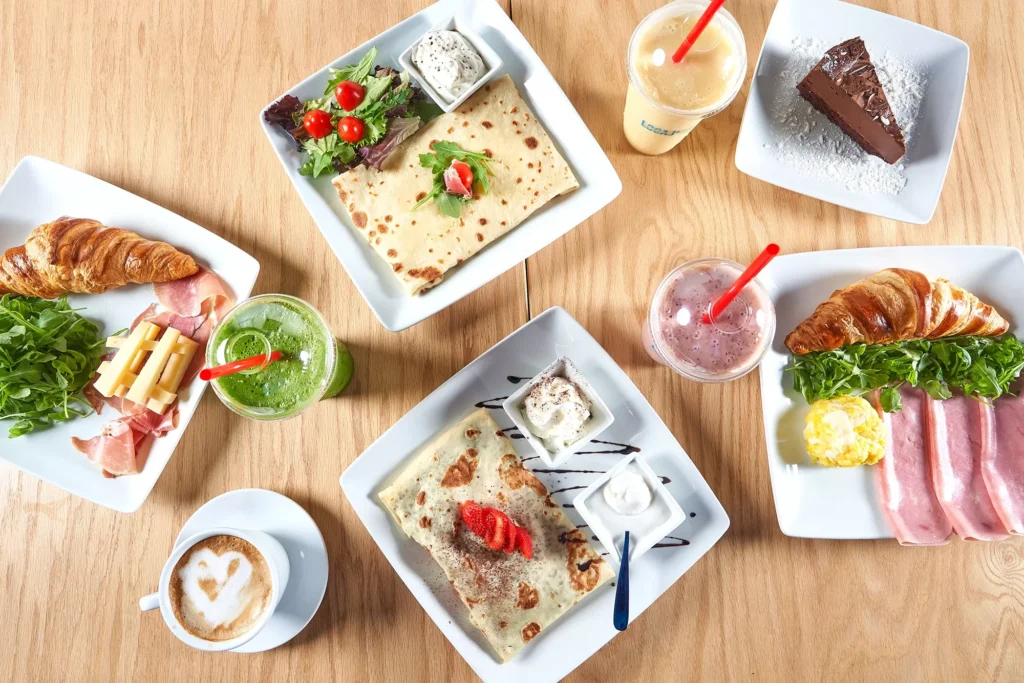 Sarasota cafe product photography of gourmet brunch spread on rustic wooden table for local restaurant marketing.