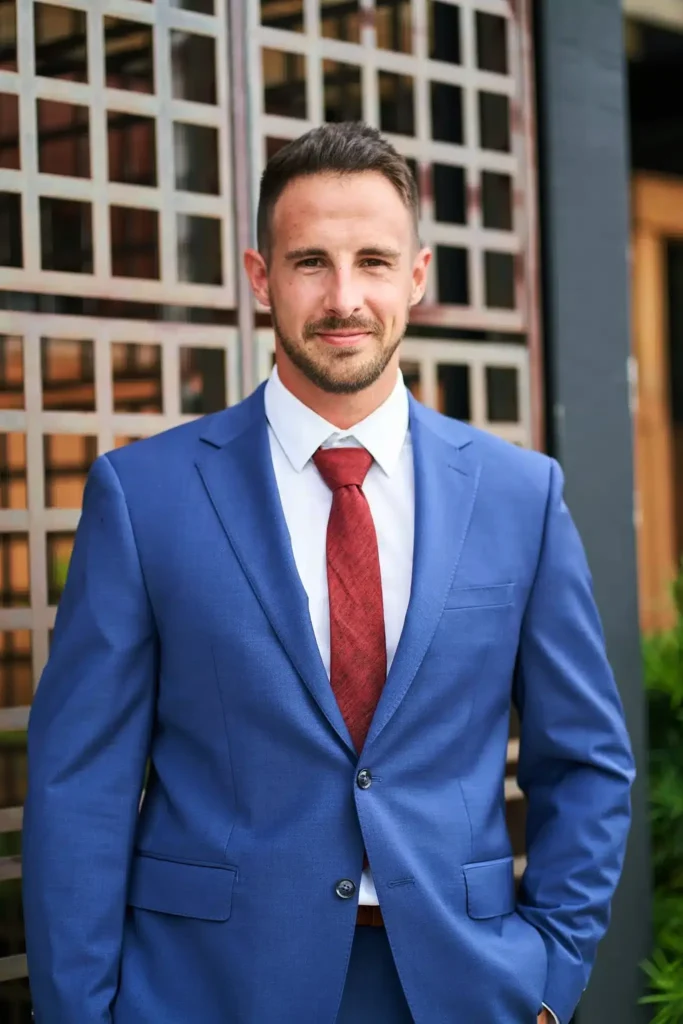 Professional headshot photography business man in suit and building in background