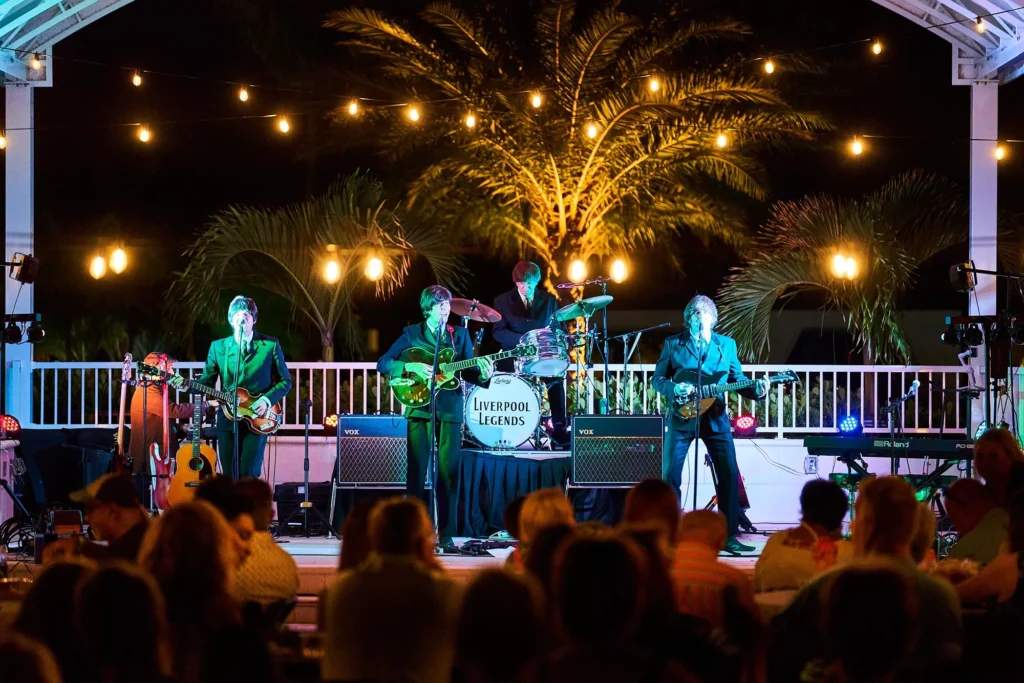 Photo of the Beatles cover band musicians performing for a live outdoor event