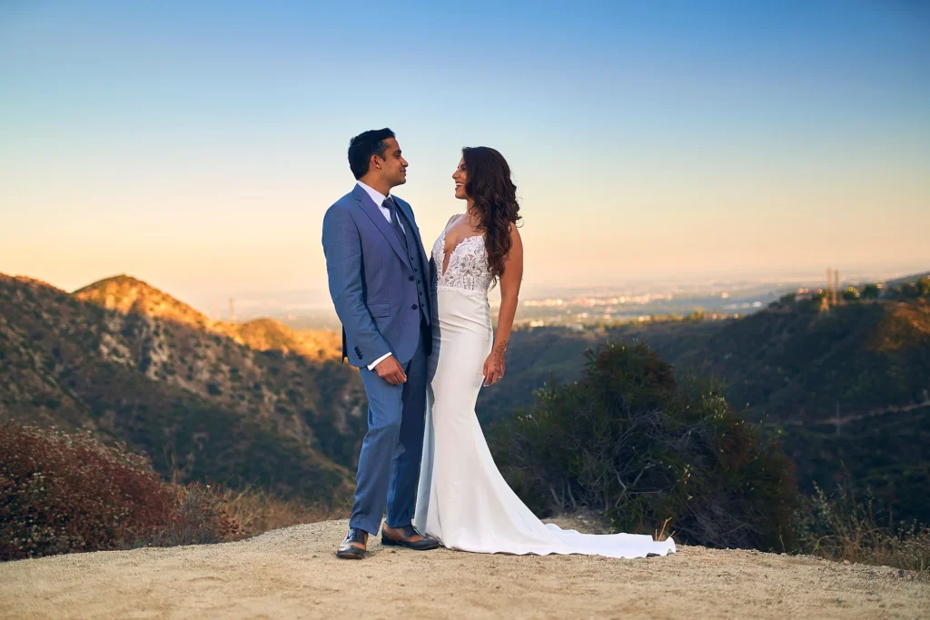 Bride and groom smiling for sunset photo on their wedding day