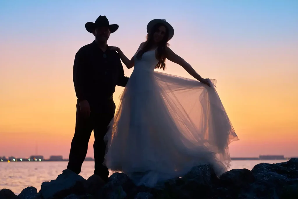 Bride and groom silhouettes posing in front of Sarasota sunset at beach photography portrait session