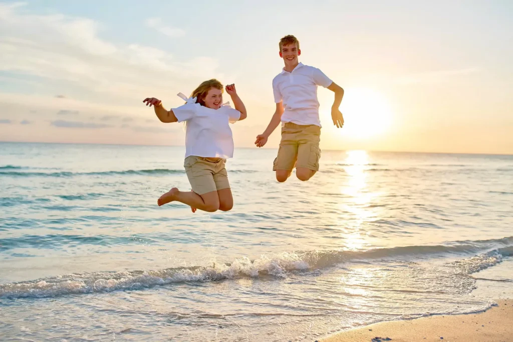 Sunset Beach Portrait Photographer of Kids Jumping at Beach Sarasota Siesta Key Moments