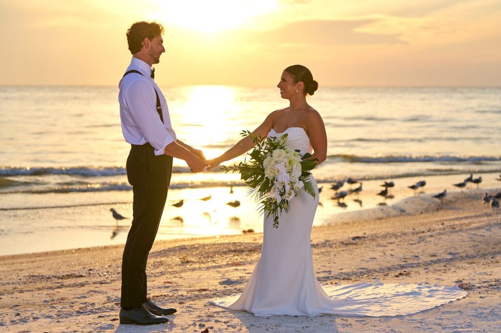 Beach Sunset Portrait Session of Elegant bride and groom holding hands