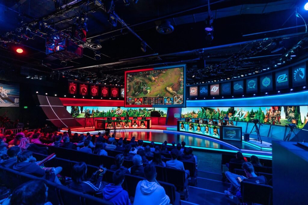 Wide-angle photograph of live event studio audience and video gaming contestants - League of Legends