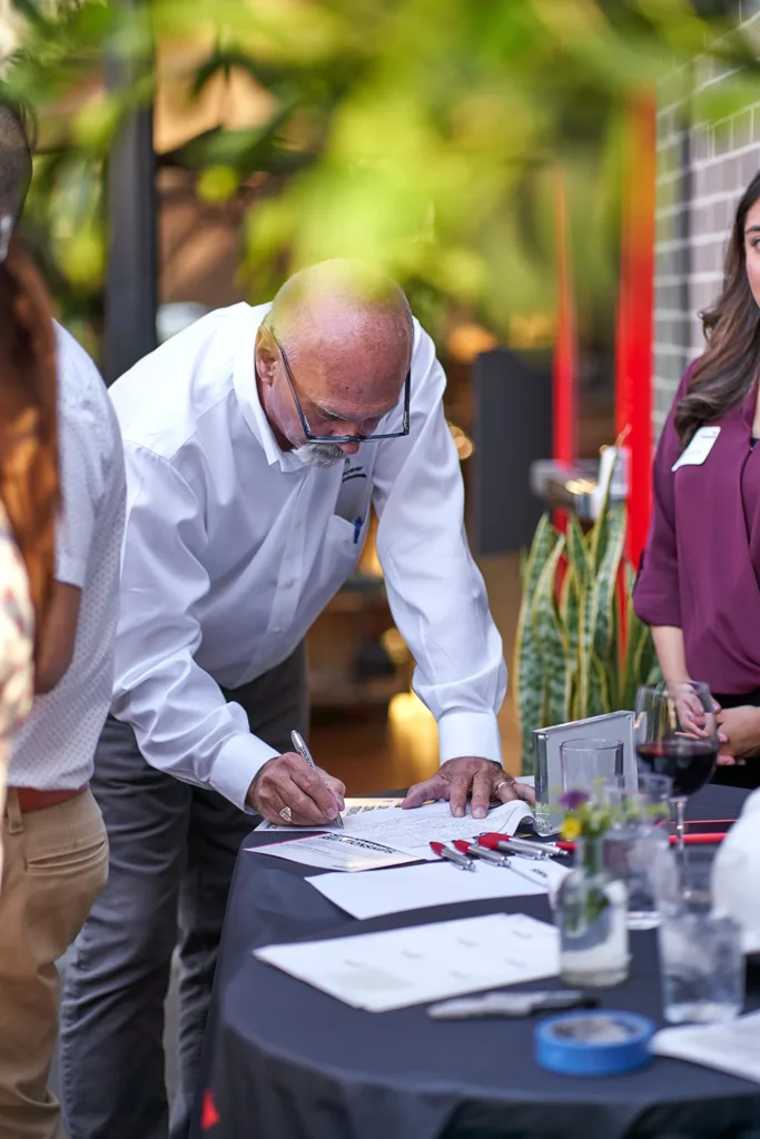 Event attendee photographed while networking at corporate event in Sarasota