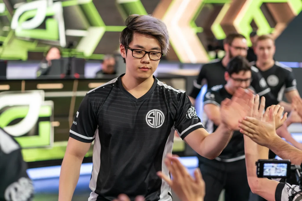 Teammates photographed while celebrating together at League of Legends live gaming event