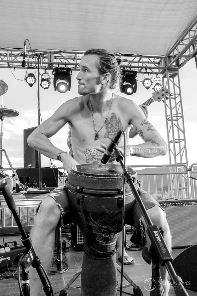 Musician portrait of live on stage drum performance at festival in black and white