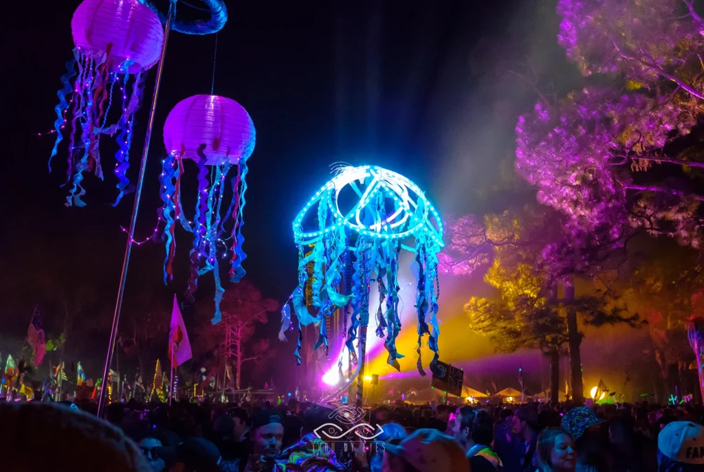 Atmospheric event photography at evening outdoor festival with lanterns and colorful lights