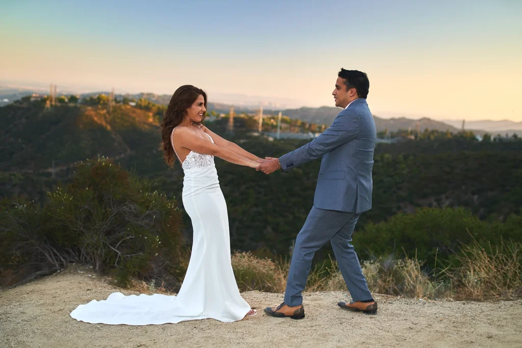A happy wedding portrait of a bride and groom with a sunlit background
