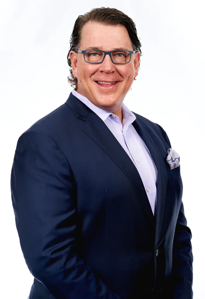 Professional business headshot photographer session of man smiling in blue suit